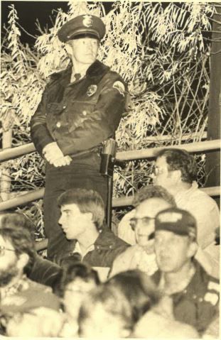 Officer Jim Anderson at the crosstown football game, 1983